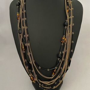 Vintage eight strand black and amber glass beads and brass tone chains